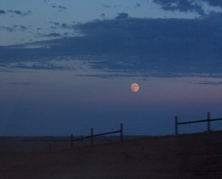 moon rising over plains